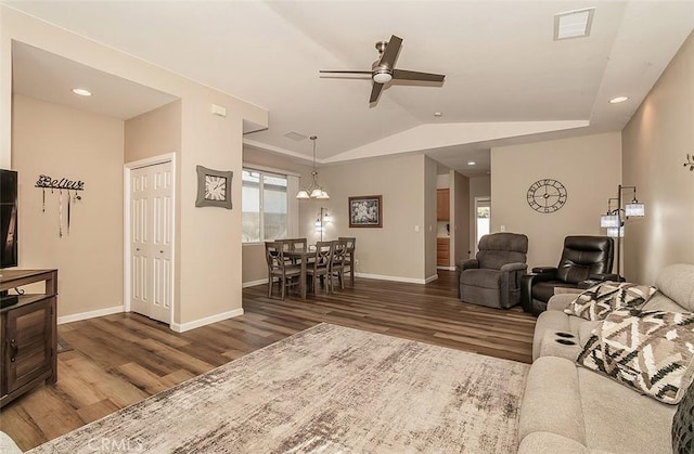 living room with dark wood-type flooring, plenty of natural light, and vaulted ceiling