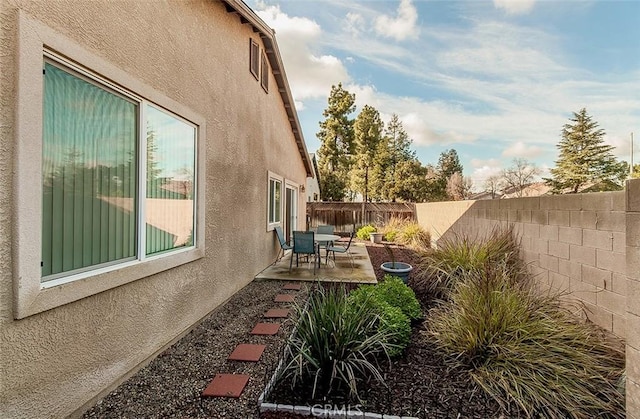 view of side of home with a patio area