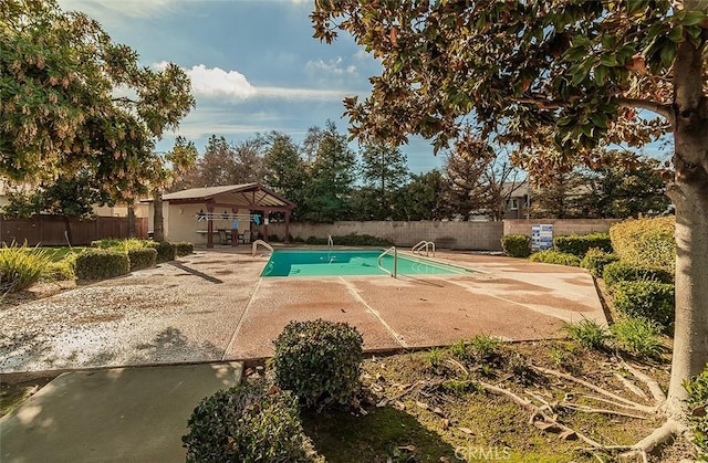 view of swimming pool with a gazebo and a patio area