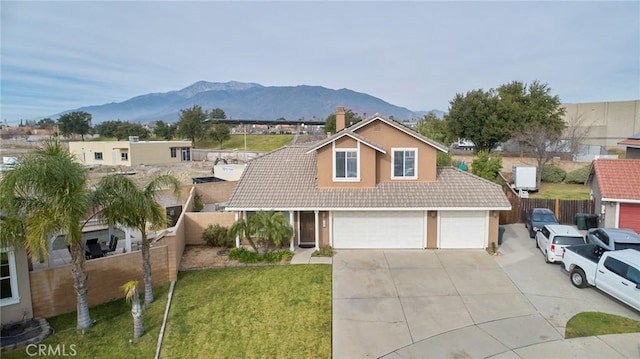 view of front of home featuring a mountain view, a front lawn, a garage, and central air condition unit