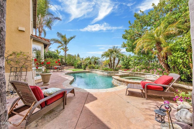 view of pool with an in ground hot tub and a patio area