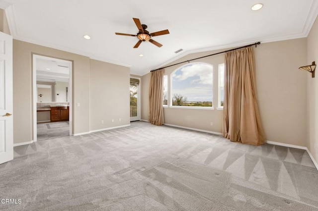 unfurnished bedroom with light carpet, ceiling fan, connected bathroom, vaulted ceiling, and crown molding