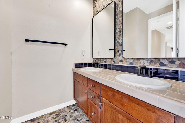 bathroom featuring tasteful backsplash and vanity