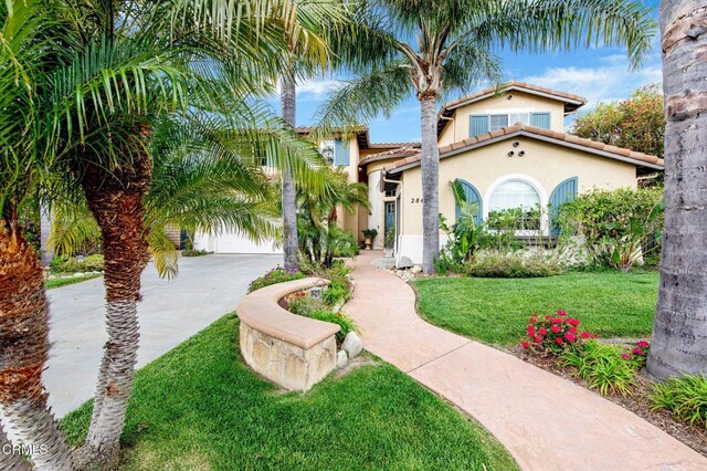 mediterranean / spanish house with a front lawn