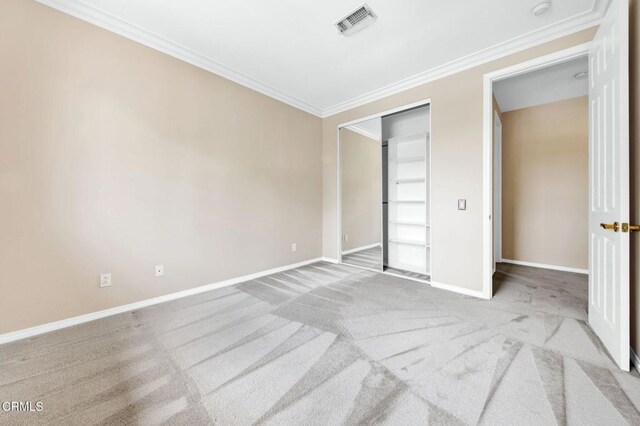 unfurnished bedroom with a closet, ornamental molding, and light carpet