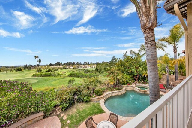 view of swimming pool with an in ground hot tub