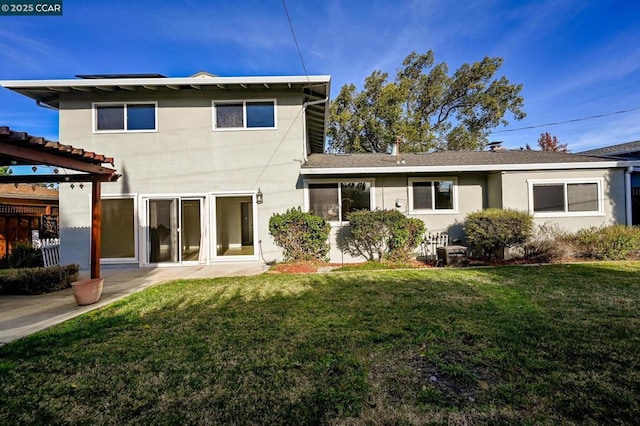 rear view of house with a lawn