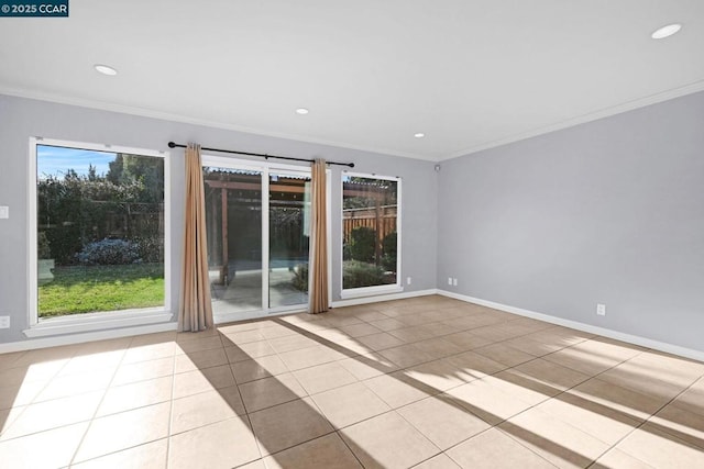 tiled spare room featuring crown molding