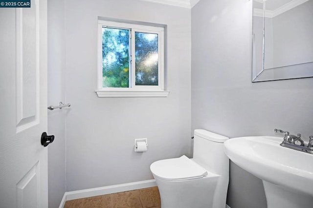 bathroom featuring toilet, tile patterned flooring, sink, and ornamental molding