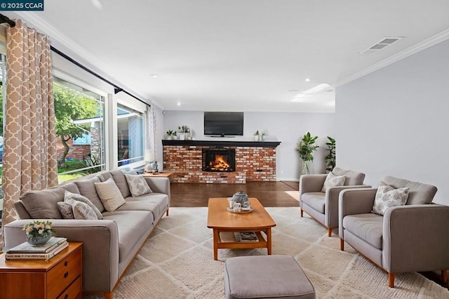 living room featuring light wood-type flooring, a brick fireplace, and crown molding