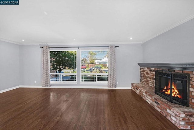 unfurnished living room featuring ornamental molding, a fireplace, and dark hardwood / wood-style floors