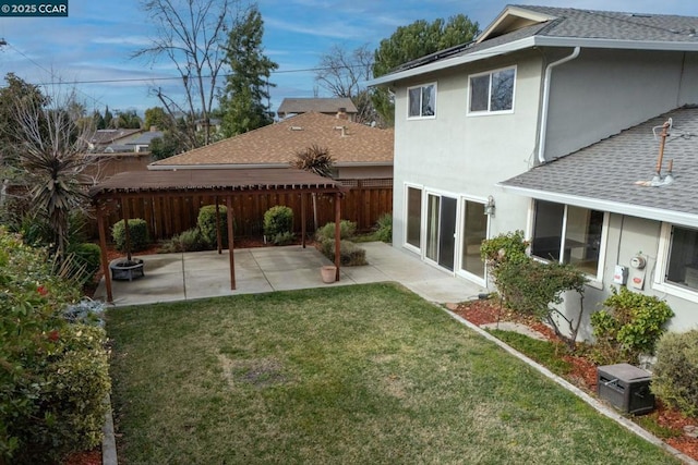 rear view of house featuring a patio area and a lawn