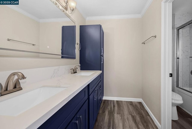 full bathroom featuring shower / bath combination with glass door, vanity, toilet, hardwood / wood-style flooring, and crown molding