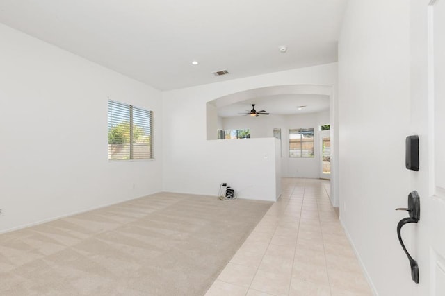 unfurnished room with ceiling fan and light tile patterned floors