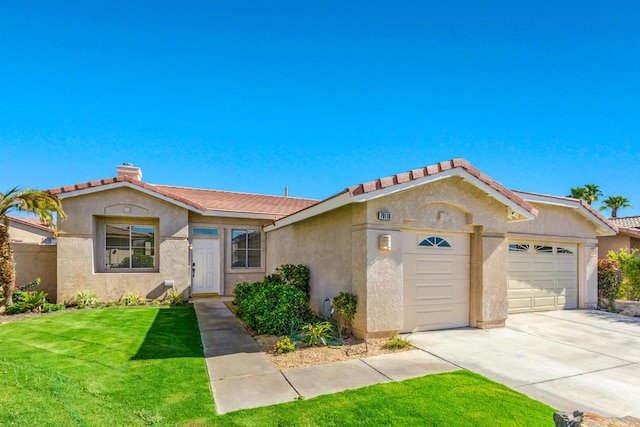 view of front of home with a front yard and a garage