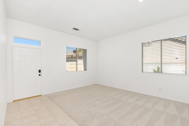 empty room featuring light colored carpet