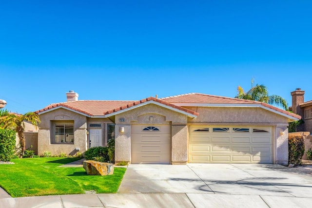 view of front of property featuring a front yard and a garage