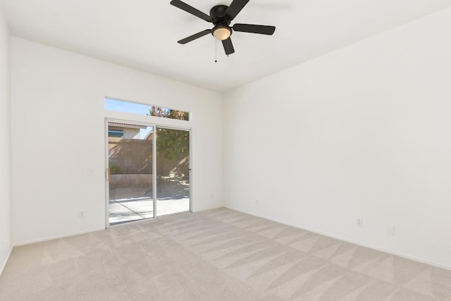 empty room featuring light carpet and ceiling fan