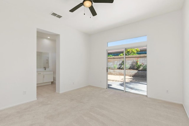 carpeted empty room with ceiling fan and sink