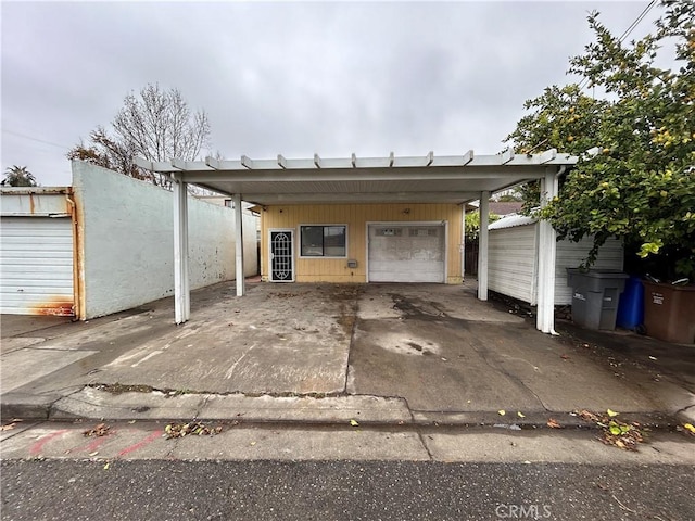 view of car parking featuring a carport and a garage