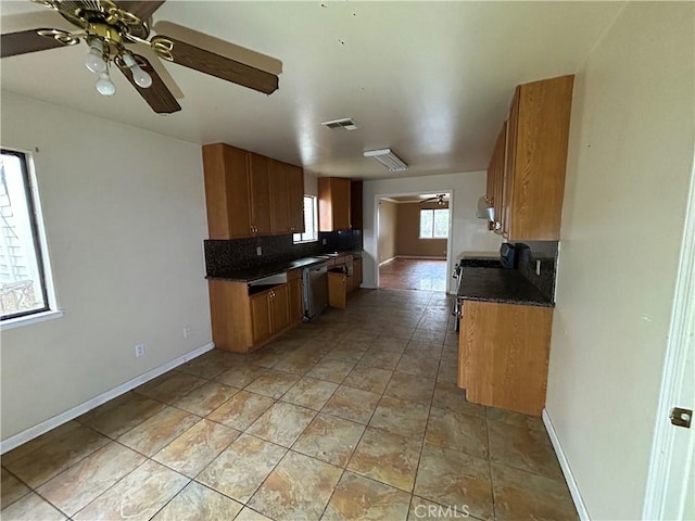 kitchen featuring stainless steel dishwasher, ceiling fan, light tile patterned flooring, and tasteful backsplash