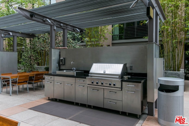 view of patio / terrace with a pergola, sink, exterior kitchen, and a grill