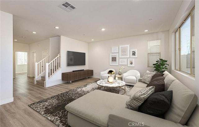 living room with plenty of natural light and light hardwood / wood-style flooring