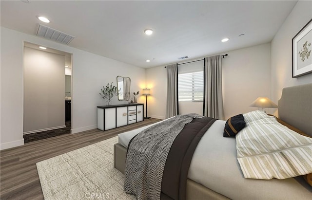 bedroom with dark hardwood / wood-style floors