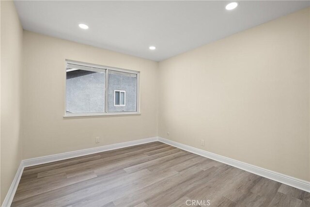 spare room featuring light hardwood / wood-style floors