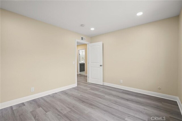 spare room with light hardwood / wood-style flooring