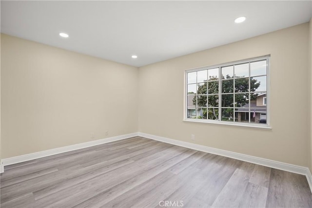 spare room featuring light wood-type flooring