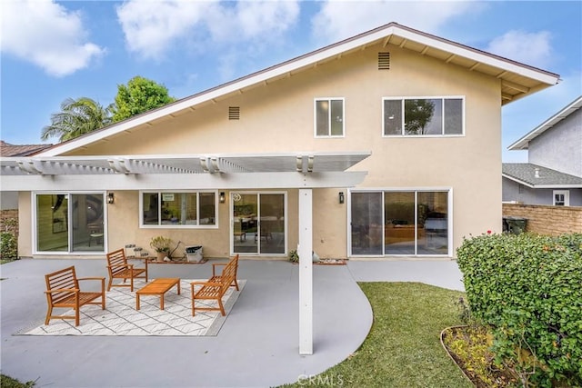 rear view of property featuring an outdoor living space, a pergola, and a patio area