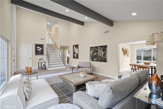 living room featuring vaulted ceiling with beams and wood-type flooring