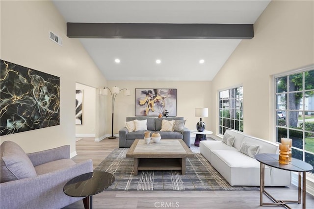 living room featuring beam ceiling, wood-type flooring, and high vaulted ceiling