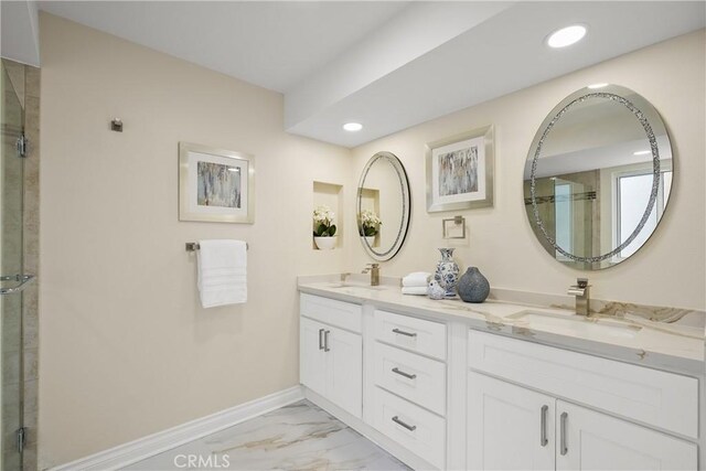 bathroom featuring walk in shower and vanity