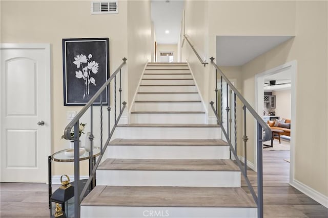 stairway with hardwood / wood-style floors