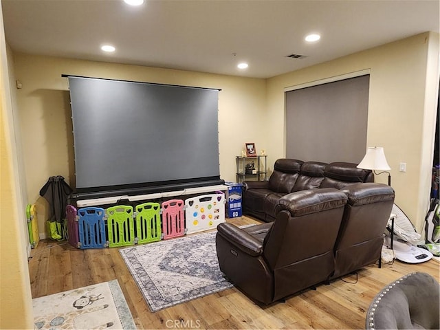 home theater room with wood-type flooring