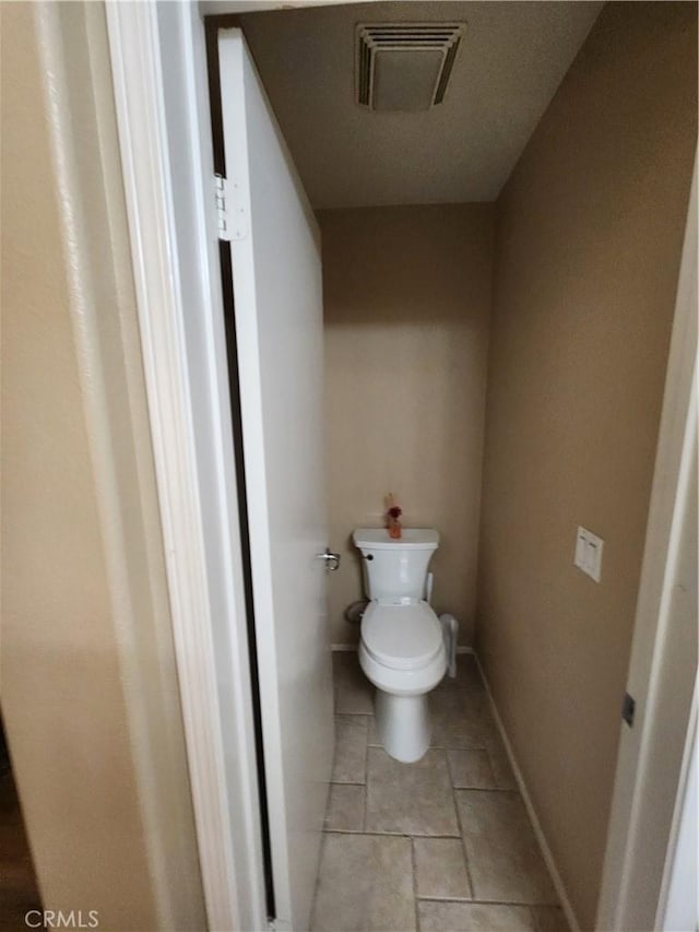 bathroom with tile patterned floors and toilet