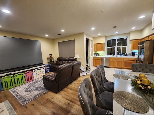 living room with sink and light hardwood / wood-style floors