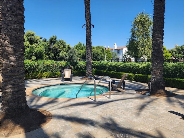 view of swimming pool with a patio and a community hot tub