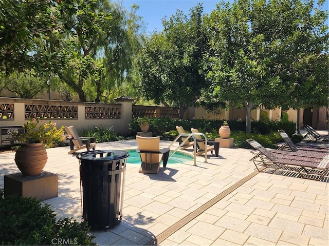 view of patio with a fenced in pool