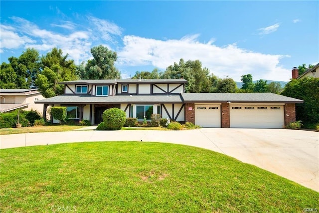 view of front of property with a garage and a front yard