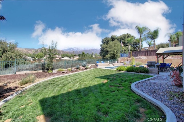 view of yard with a gazebo, a patio area, a mountain view, and a fenced in pool