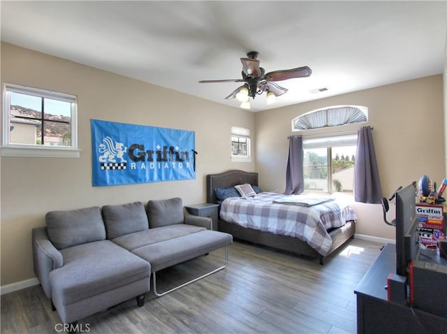 bedroom featuring ceiling fan and dark hardwood / wood-style floors