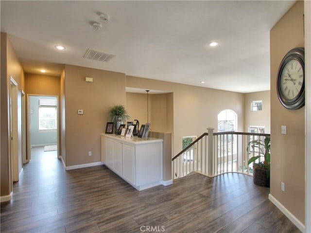 hallway with dark hardwood / wood-style flooring