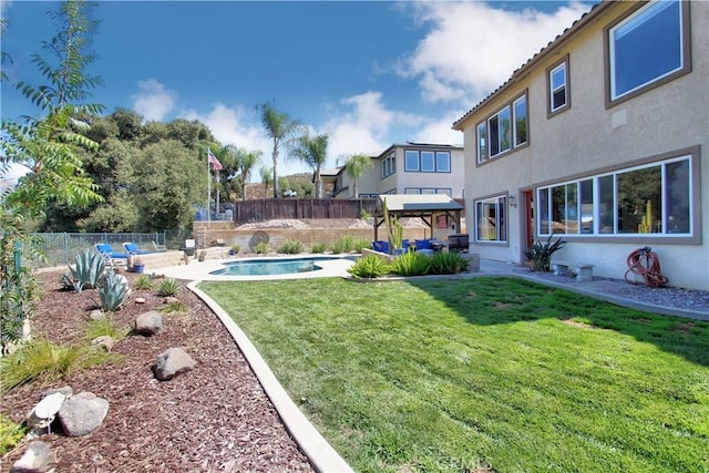 view of yard with a patio area, a fenced in pool, and a gazebo