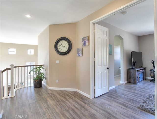 hallway with hardwood / wood-style flooring