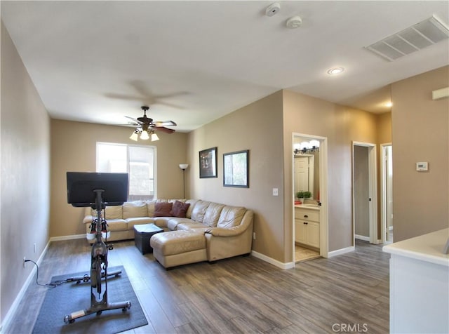 living room with ceiling fan and hardwood / wood-style floors