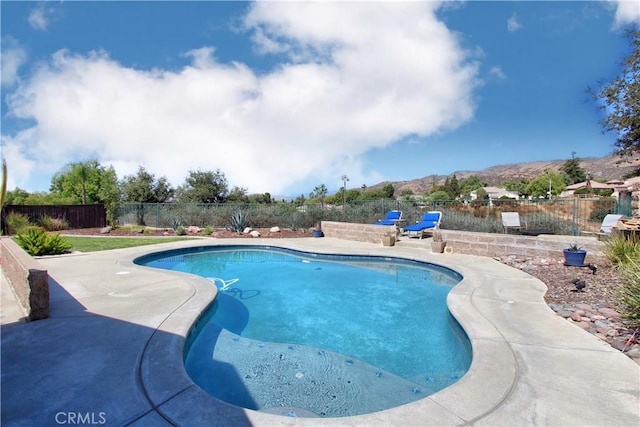 view of pool featuring a mountain view and a patio