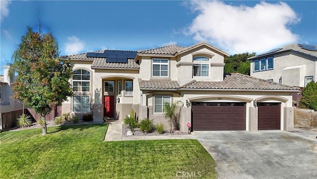 mediterranean / spanish house featuring a garage, solar panels, and a front yard